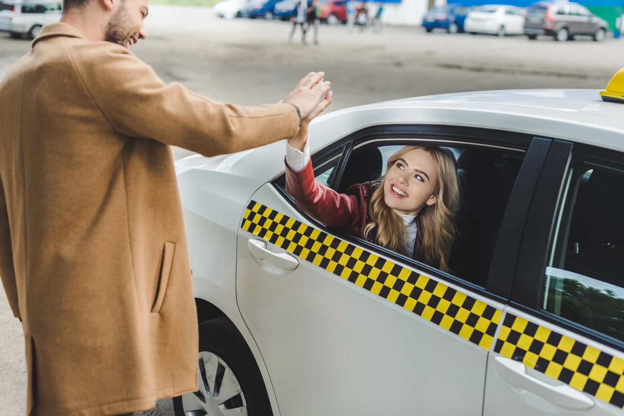 A passenger in a taxi saying goodbye before a journey