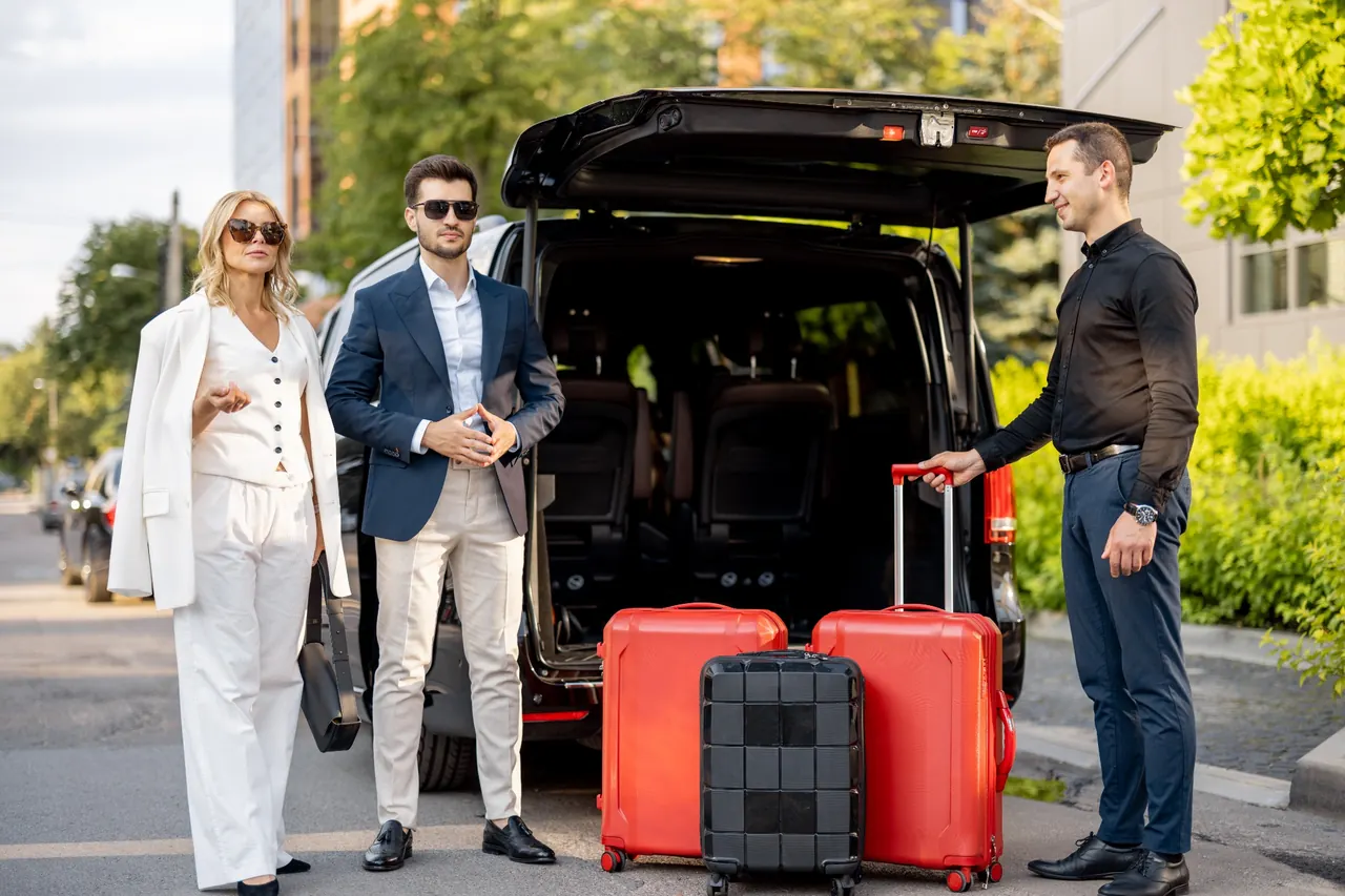 Passengers with luggage beside a minivan
