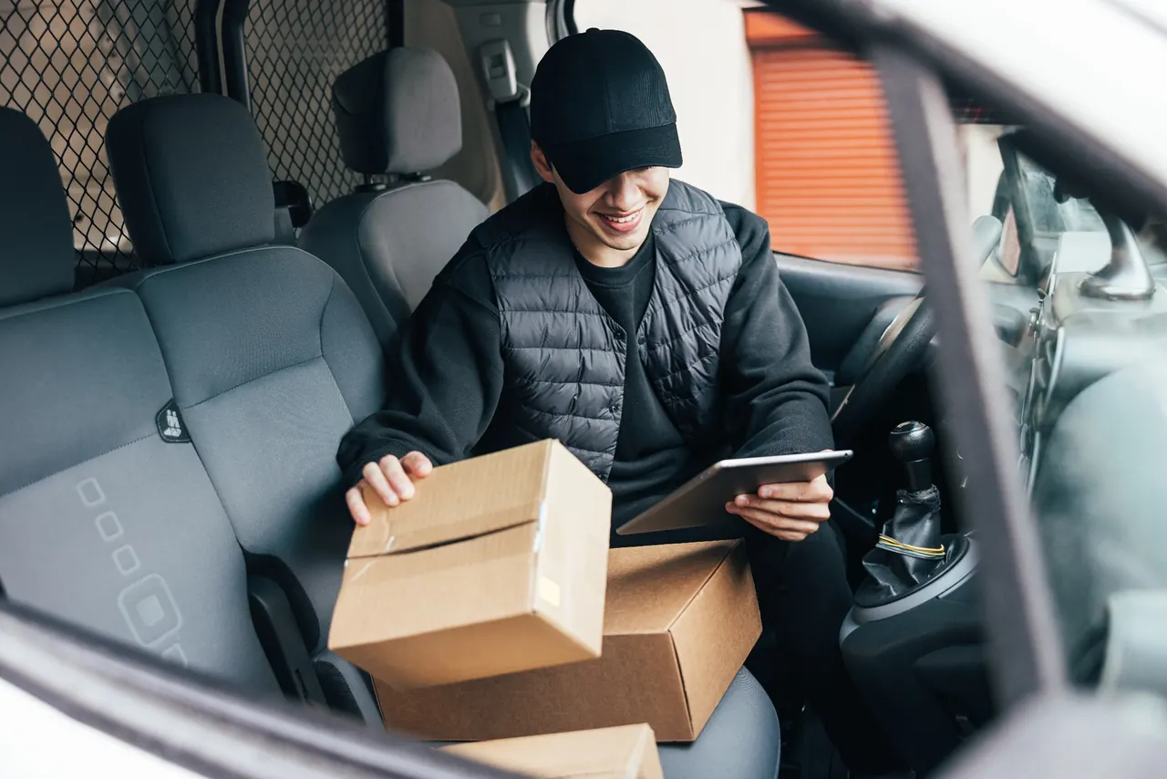 Courier checking parcels with a tablet